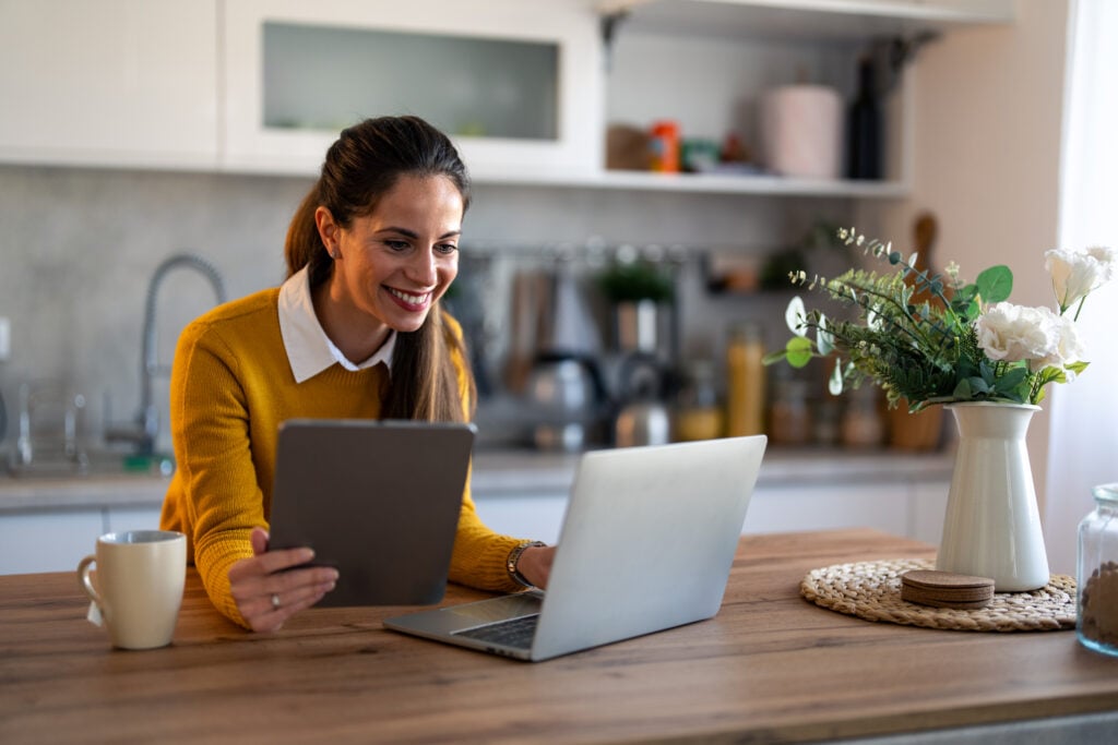 Smiling female business person watching training webinar or having a video conference on laptop